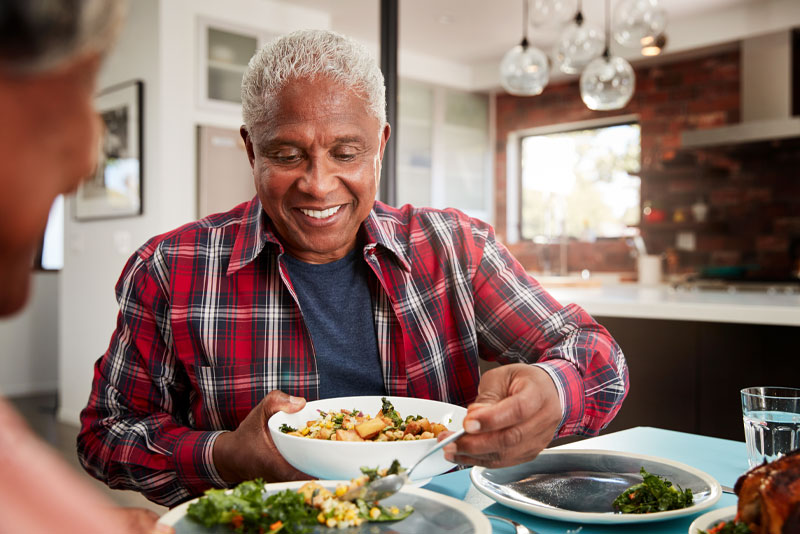 a smile makeover patient smiling at a dinner table.
